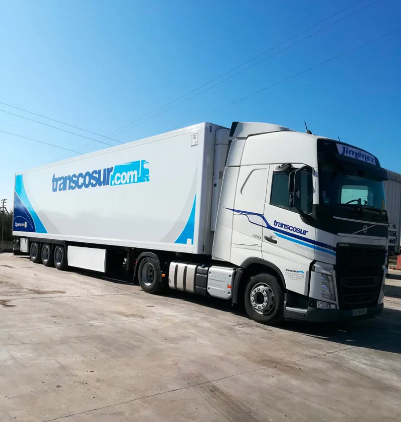 Camión de Transcosur con semirremolque cerrado aparcado, visto de lado
